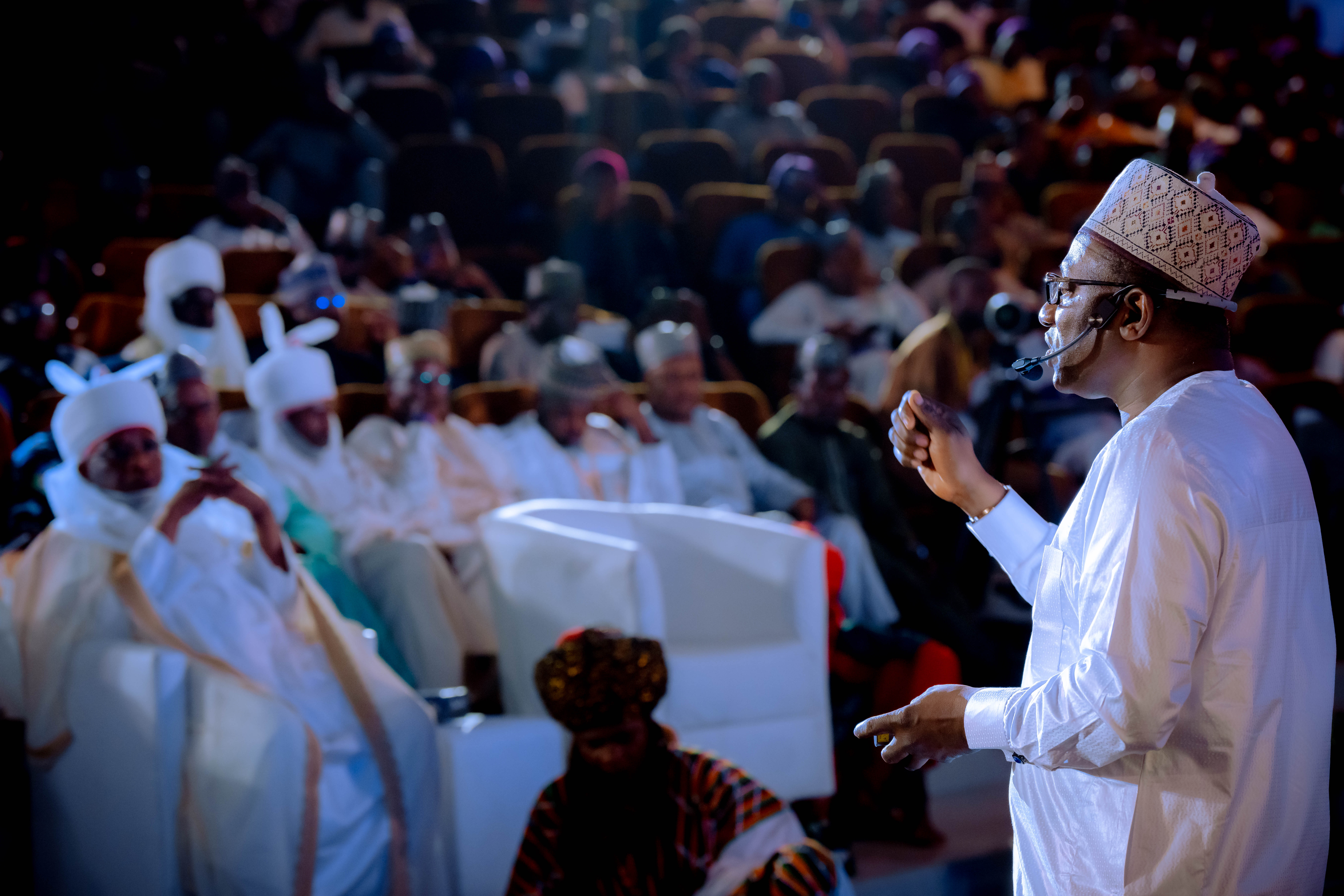 A stakeholder reviewing BWSO's 'Building Bauchi State by Ourselves' brochure, featuring a message from Dr. Bala Wunti